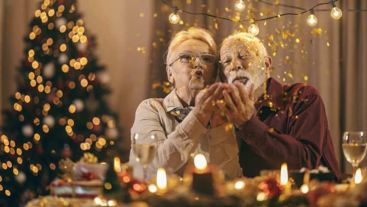 Old woman and man blowing glitters