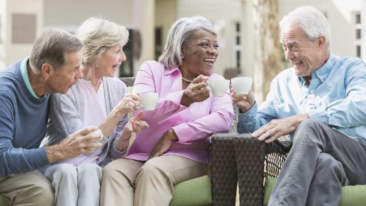 Older people enjoying a conversation over coffee at {{location_name}} in {{location_city}}, {{location_state_name}}