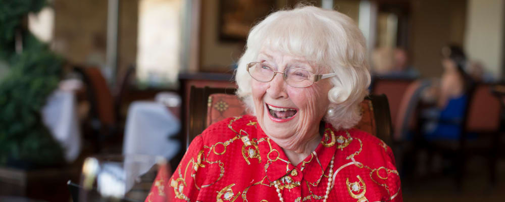 A smiling resident at Garden Square of Greeley Memory Care in Greeley, Colorado