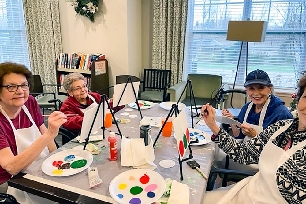 Residents participating in a painting activity at Anthology of Burlington Creek in Kansas City, Missouri