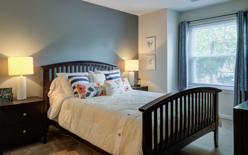 Model bedroom with side door at The Apartments at Diamond Ridge in Baltimore, Maryland