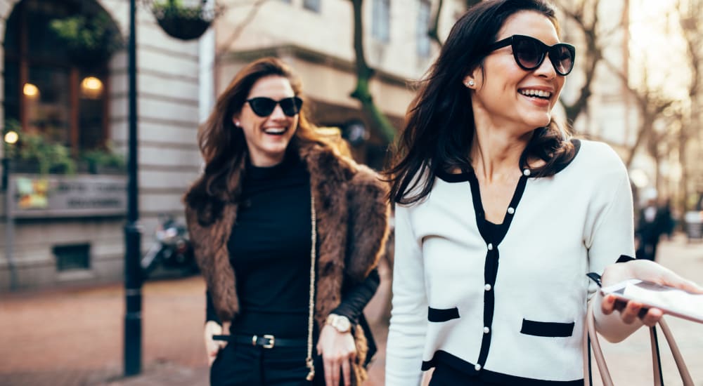 Two smiling women walking around town near EOS in Orlando, Florida