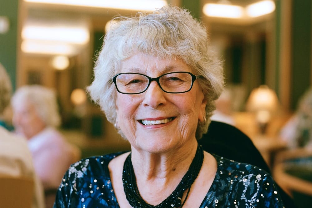 Resident smiling in dining room at Merrill Gardens at Columbia in Columbia, South Carolina