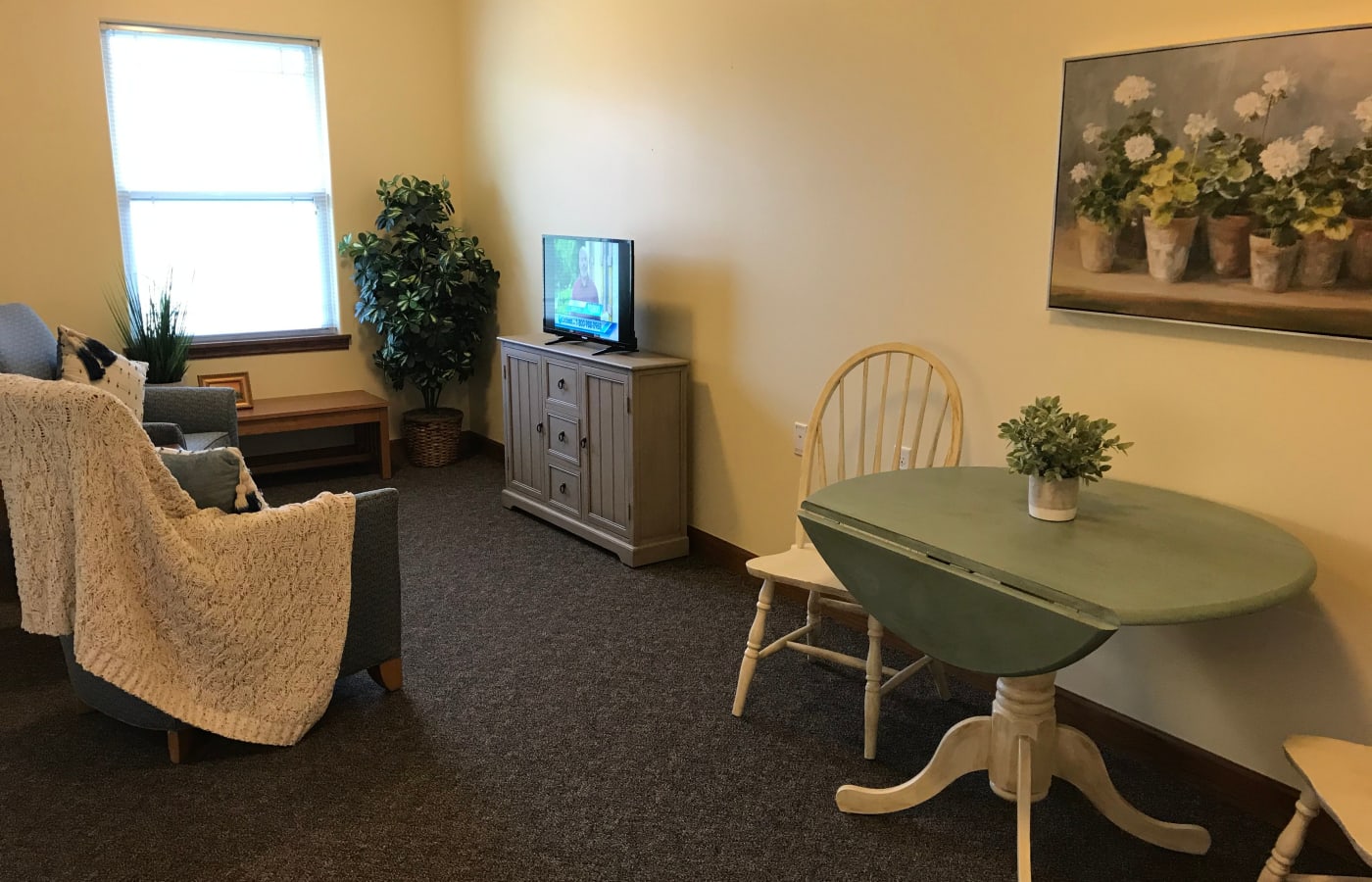 A dining area and living room in an apartment at Prairie Hills Senior Living in Des Moines, Iowa