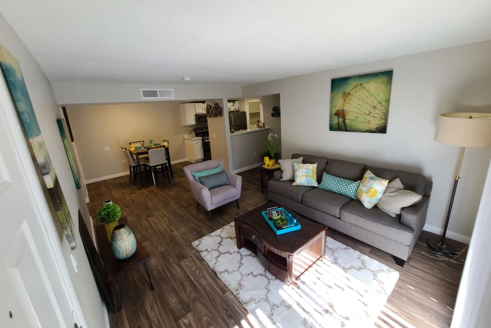 Well-furnished model home's living area with wood-styling at Alterra Apartments in Las Vegas, Nevada