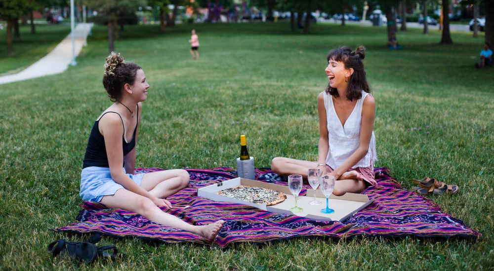 Resident friends having a picnic in park near The Lofts at 305 in Bryan, Texas