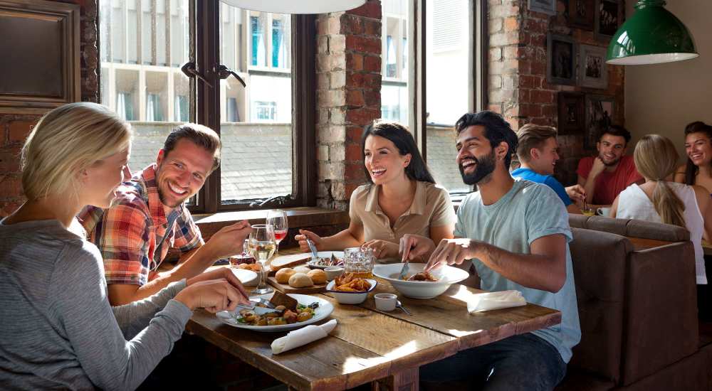 Friends enjoying food at a restaurant near Bonita Ranch in Sylmar, California