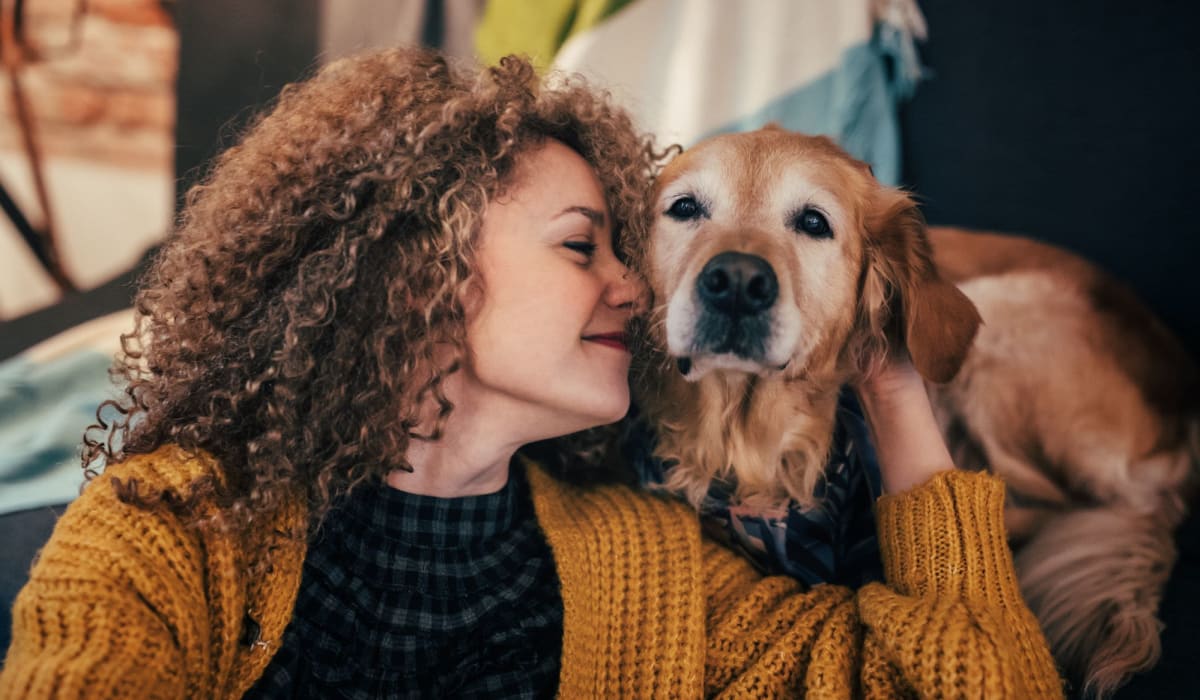 Resident and dog snuggling at Landmark Apartments Phase II in Little Rock, Arkansas