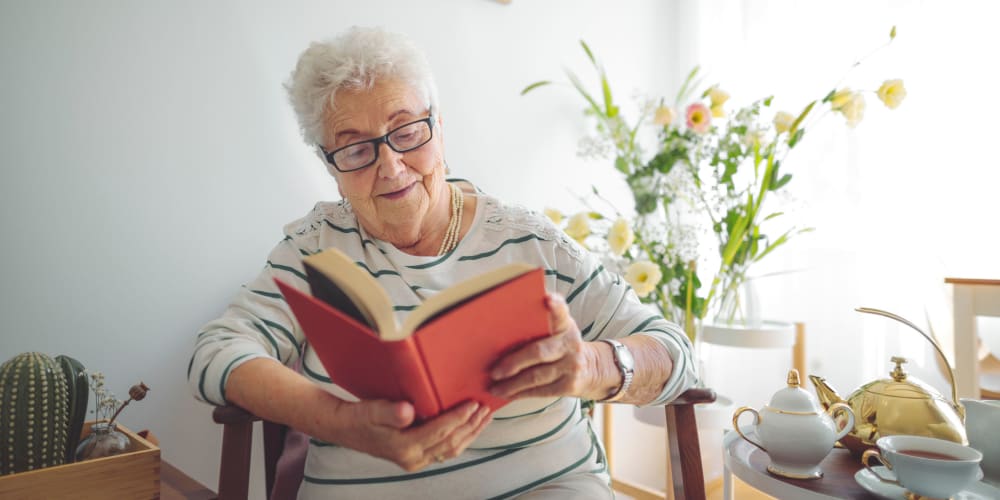 Resident reading a book at Vista Prairie at Monarch Meadows in North Mankato, Minnesota