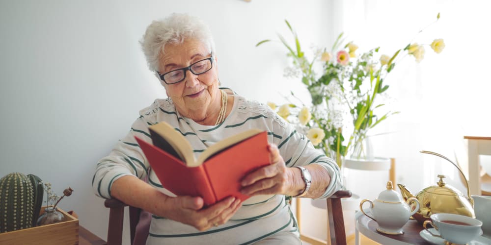 Resident reading a book at Vista Prairie at Brentwood in Rice Lake, Wisconsin