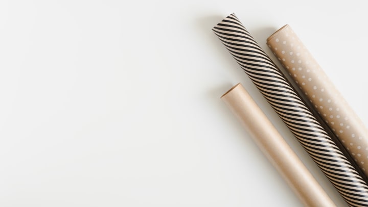 Classy gold white and black wrapping paper rolls on a white background