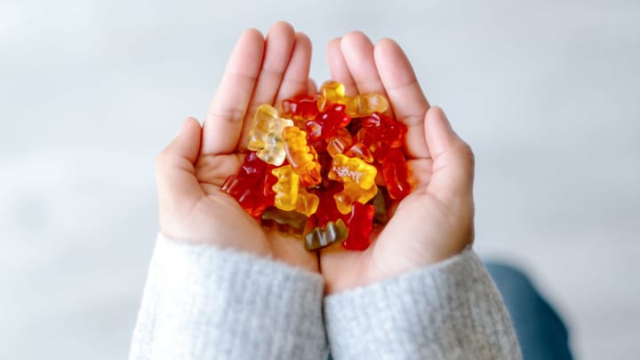 Hands holding gummy bears at The Davis in Fort Worth, Texas