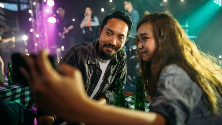 Couple taking a selfie at a live music performance