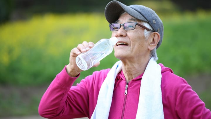 Senior Citizen staying hydrated after a workout