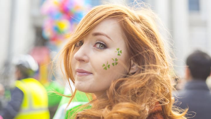 Red-haired girl with shamrock face paint