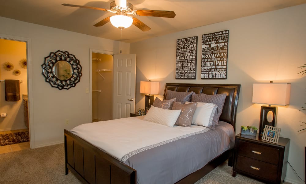 Primary bedroom with a ceiling fan at Tuscana Bay Apartments in Corpus Christi, Texas