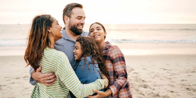A family embracing on a beach near Admiral Hartman in San Diego, California