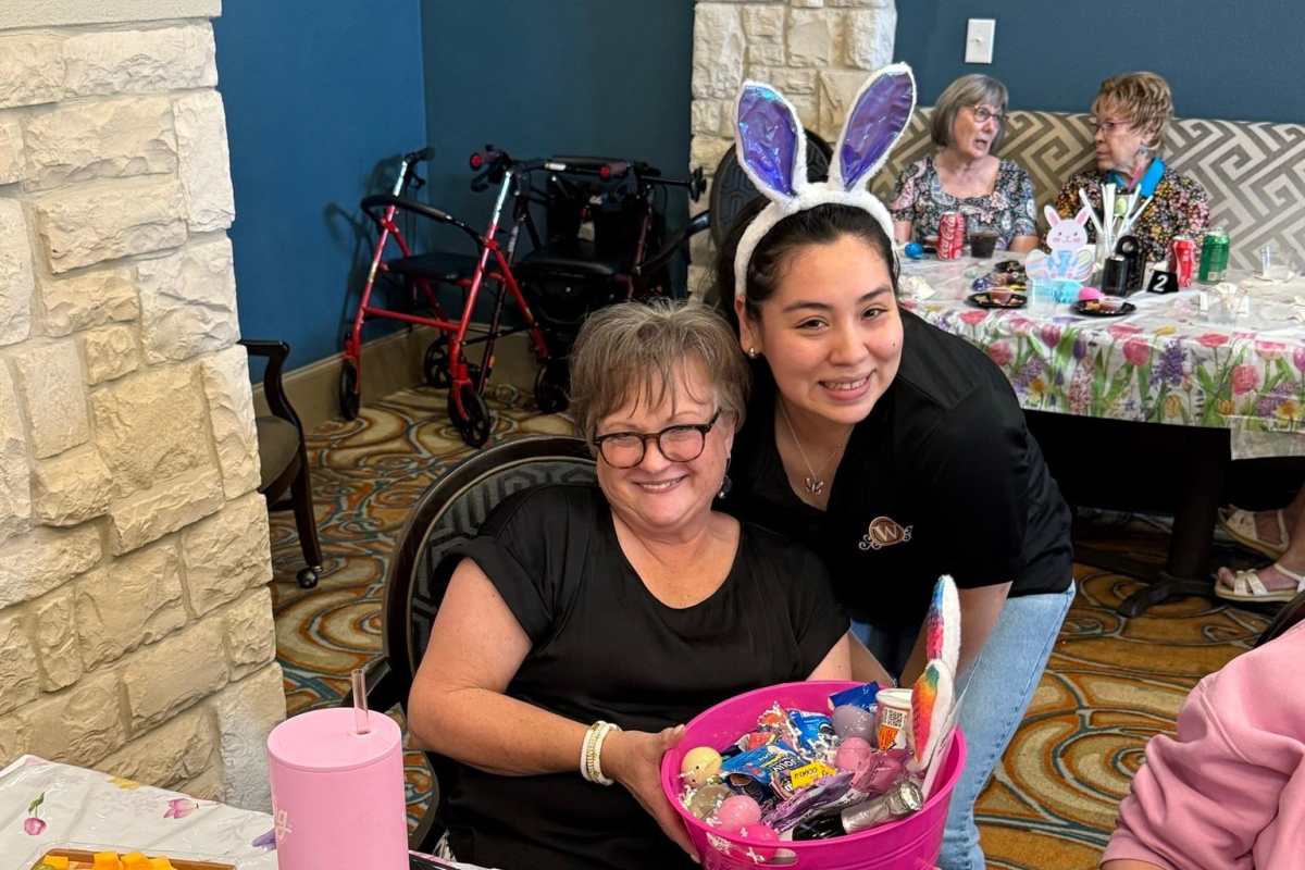 Residents sharing a moment with a staff member at Watercrest at Katy in Katy, Texas
