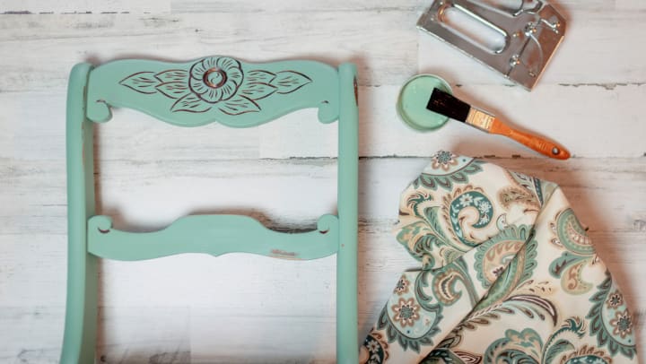 Furniture items being refinished and refreshed with paint and fabric.