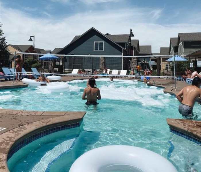 Residents playing volleyball in the pool at College Town Mankato in Mankato, Minnesota