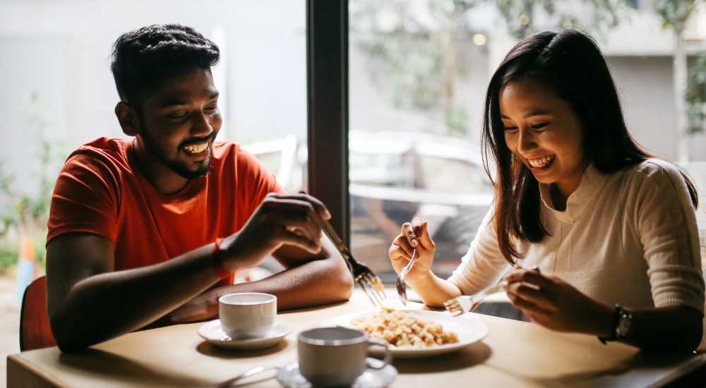 Resident couple dining in local restaurant near Pike West Commerce in Dallas, Texas