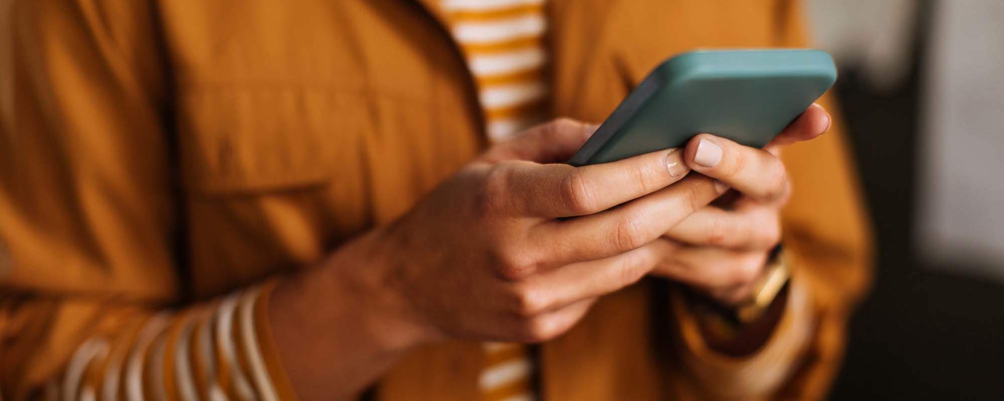 Reviews | A resident holding their phone at Tides on Tropicana in Las Vegas, Nevada