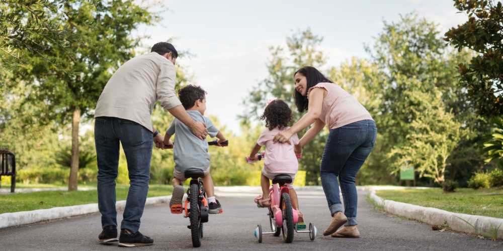 Happy family enjoying the weather and biking near Encore at West Valley in White Lake, Michigan