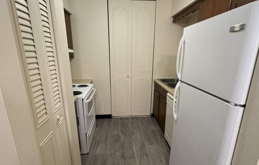 Modern kitchen with white appliances at Mount Vernon Arms Apartments in Merrillville, Indiana