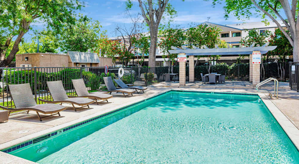 Pool with lounge chair at Independence Park Apartments in Canoga Park, California