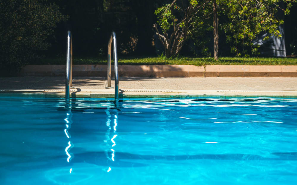 Resident mother and daughter playing in the swimming pool at Carden Place Apartment Homes in Mebane, North Carolina