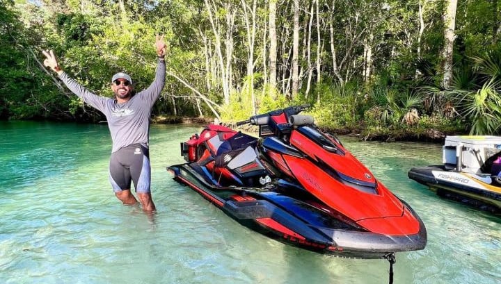 Dan standing next to a jet ski