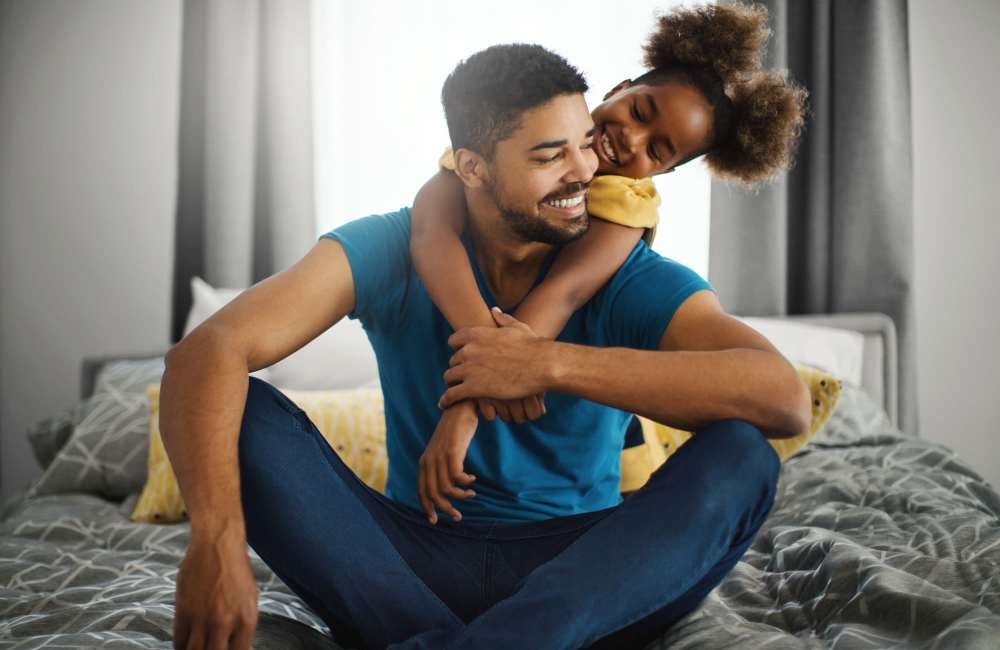 A cute duo of father and daughter in their apartment bedroom at Creekwood Place in Lancaster, Texas