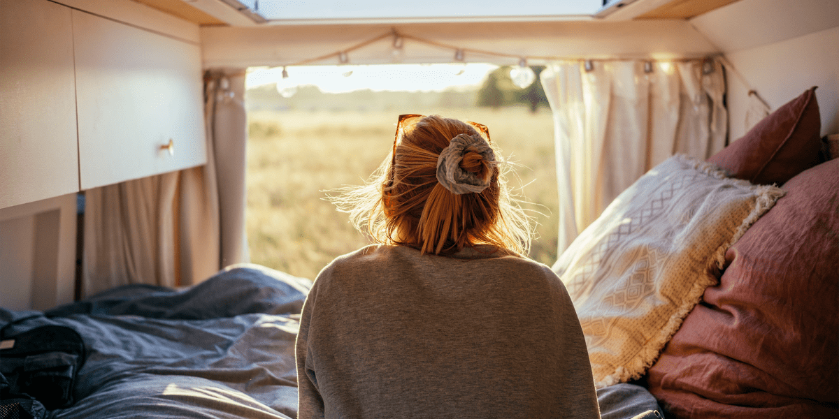 A woman waking up in an RV vehicle from Capital City Self Storage in Salem, Oregon