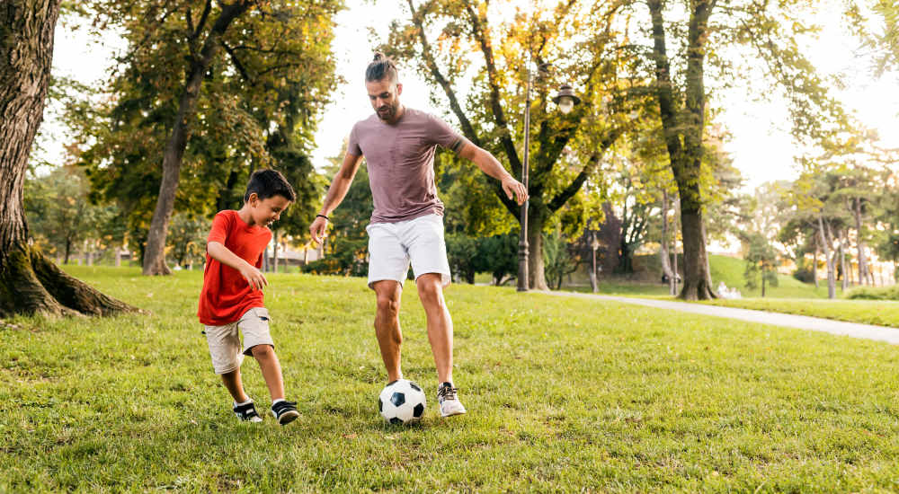 Residents playing football in park near Baxter Apartments in Bozeman, Montana
