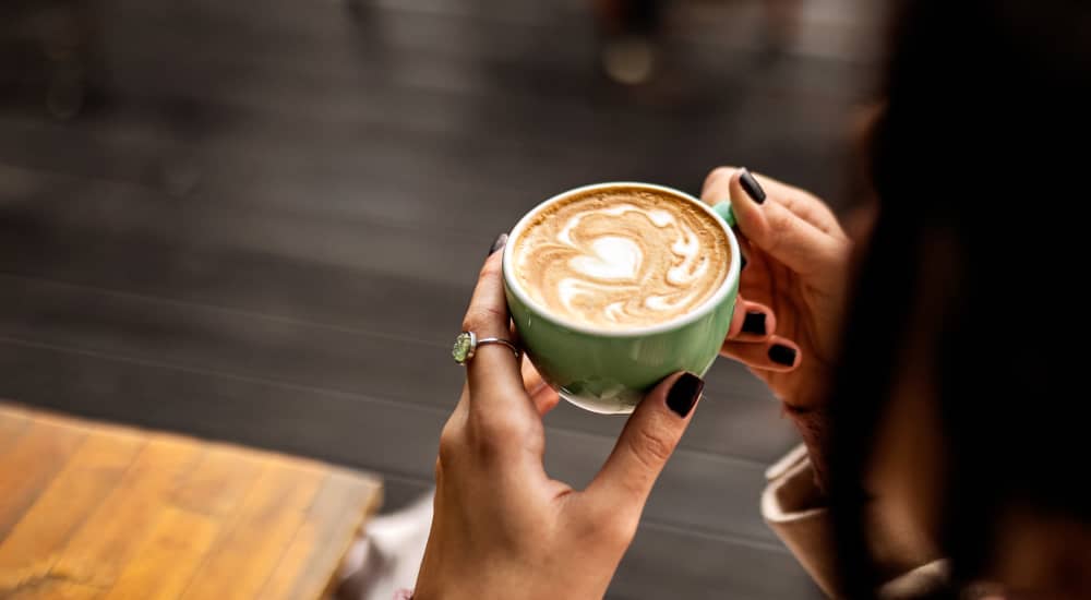 Woman having coffee at a café near Royal Gulf Apartments in Biloxi, Mississippi