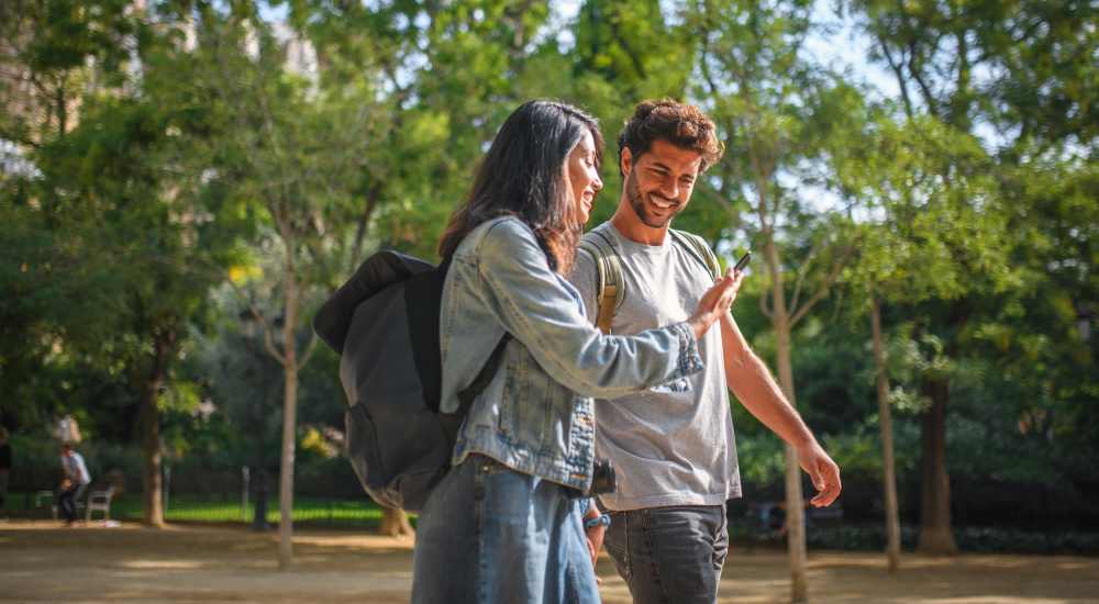 Two students walking in a park near The Ivy in College Station, Texas
