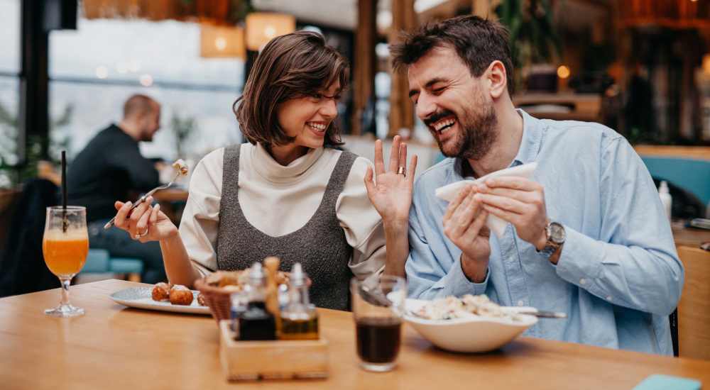 Friends enjoying food at a restaurant near El Cajon Sr Towers in El Cajon, California