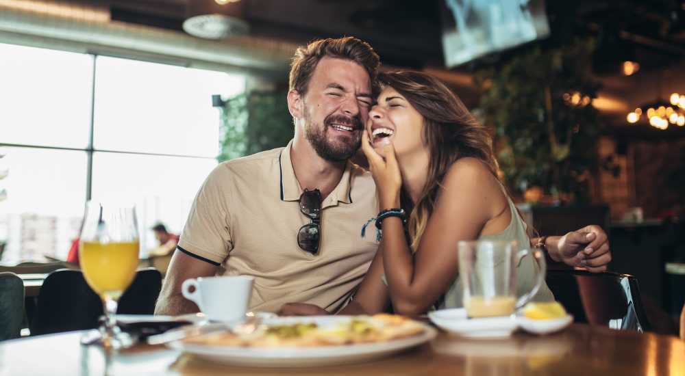 Happy couple having meals at their favorite restaurant near Forest Glen in Lake Forest, California
