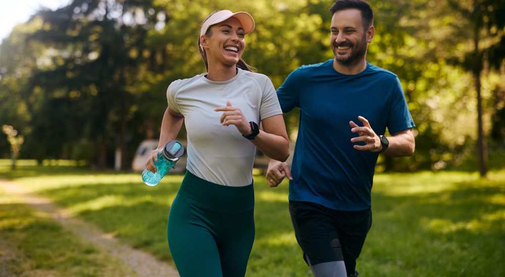 Resident couple jogging at a park near The Victorian in Dallas, Texas