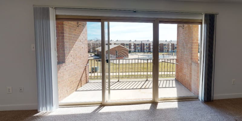 Doors to patio letting in natural light at Rolling Park Apartments in Windsor Mill, Maryland