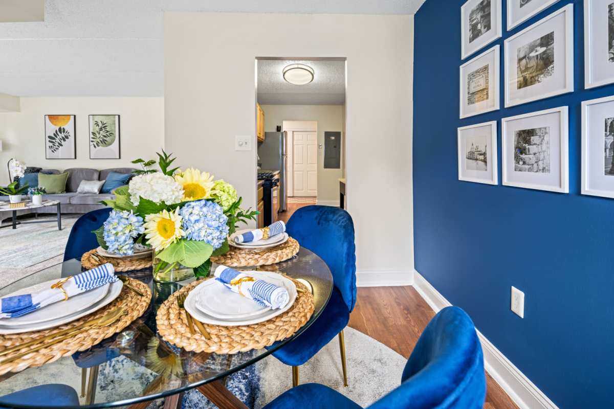 Dining area with a table, chairs and a view of the living room at Windsor Court and Tower in Silver Spring, Maryland