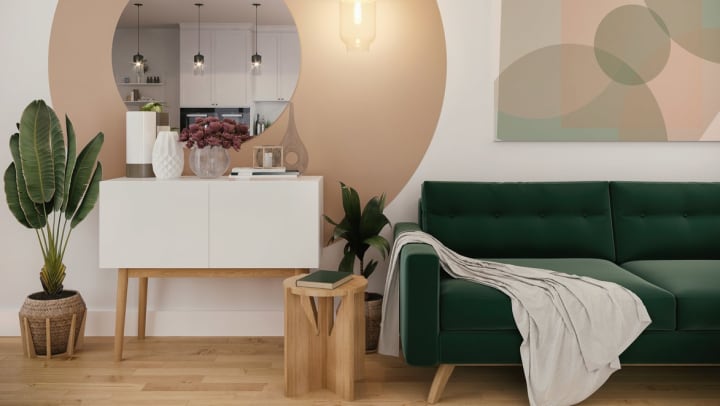 Room with decorative mirror, canvas, blanket, and side table