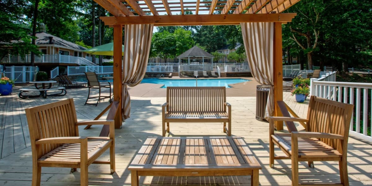 Covered seating by a resort-style pool at a Saratoga Capital Partners property