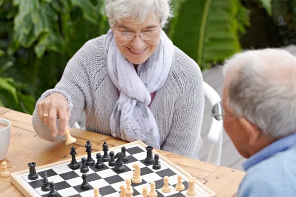 Residents playing cards at Carnegie Heights at Henderson