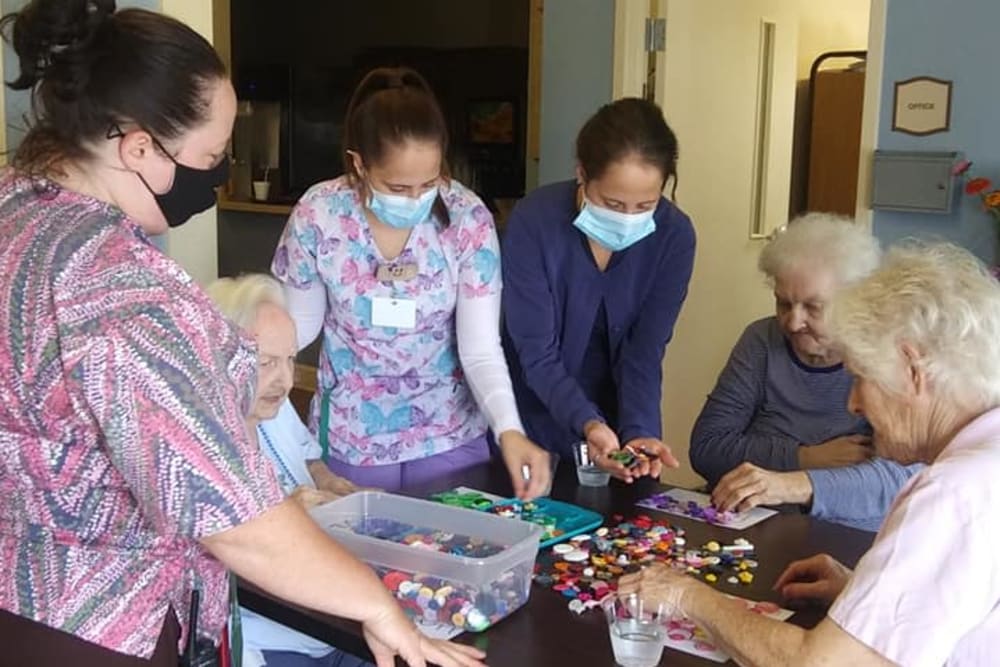 caretakers helping with arts and crafts at English Meadows Lexington Campus in Lexington, South Carolina