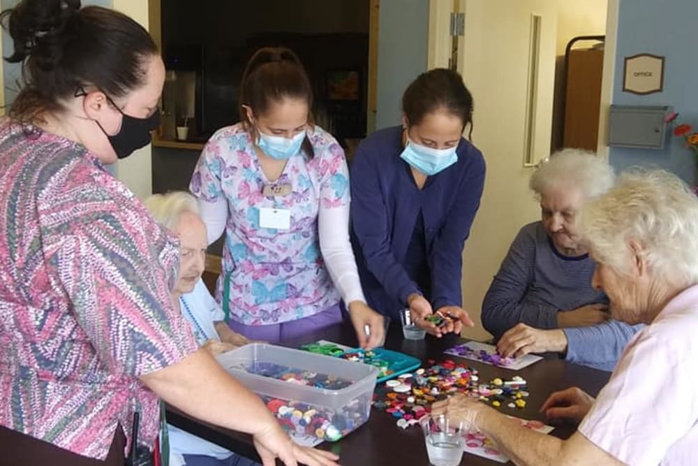 caretakers helping with arts and crafts at English Meadows Stephens City Campus in Stephens City, Virginia