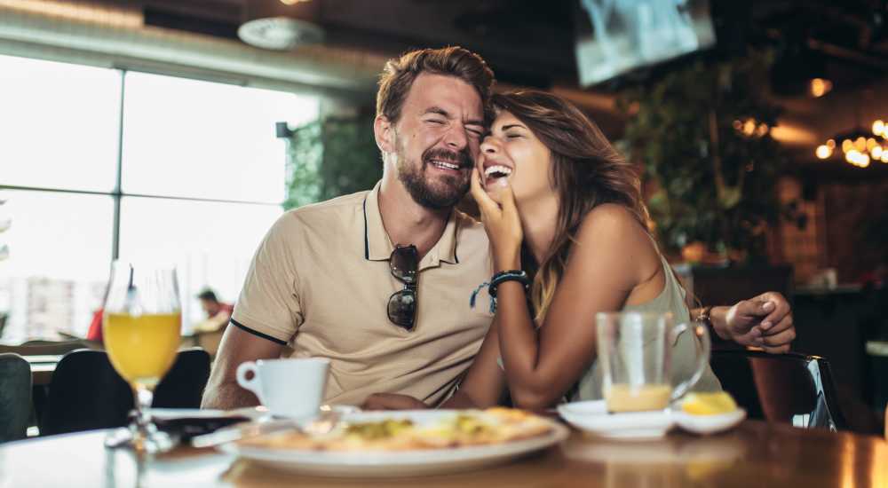 Resident couple having meals at a restaurant near Villas of Brighton in Rochester, New York