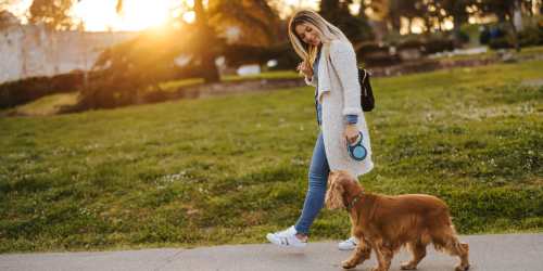 Resident taking her dog for a walk near Witmer Manor in Los Angeles, California