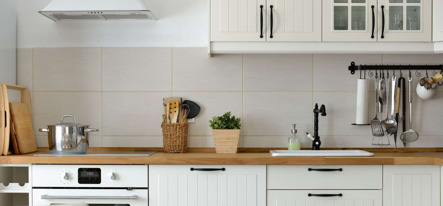 Kitchen with white appliances at Woodstock Square in Joshua, Texas