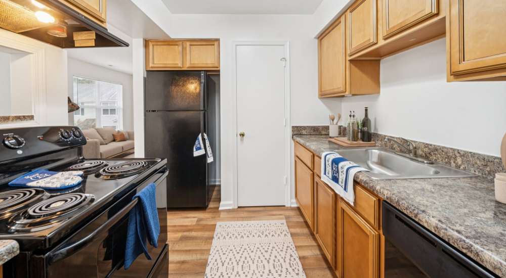 Kitchen with black appliances at Maplewood in Chesapeake, Virginia